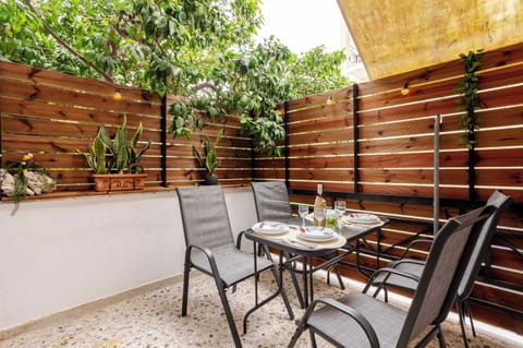 Private outdoor patio with stylish seating and cozy dining area – perfect for relaxing evenings in the heart of the city.