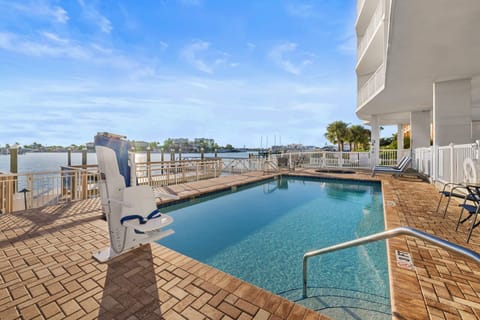 Take a refreshing dip in the inviting pool, perfectly set against the serene bay backdrop.