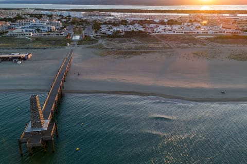 Aerial view of Port Leucate marina at dusk — restaurants, shops and the port village just 1 km away.