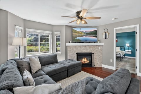 Spacious living room with plentiful seating, smart TV and fireplace
