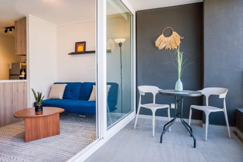 Relax on your private balcony with stylish seating and enjoy seamless indoor-outdoor living in this cozy studio apartment.