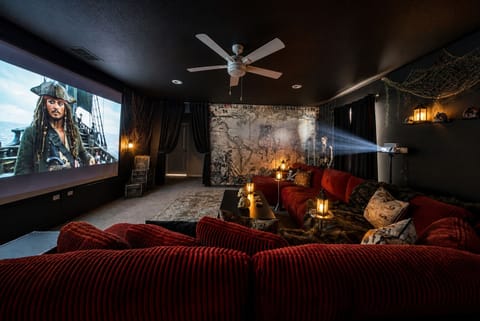 Pirate-themed home theater with projector screen and plush lounge seating