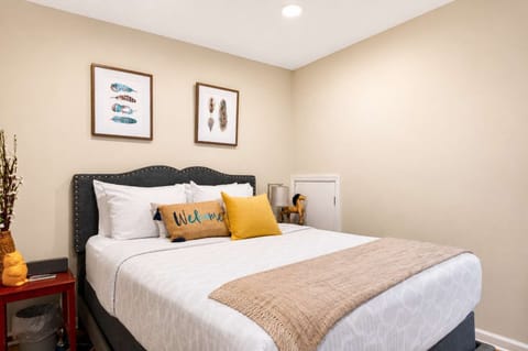 Bedroom 1: Relax in this cozy bedroom featuring a plush queen-size bed, soft linens, ample storage, and a peaceful atmosphere for a restful night's sleep.
