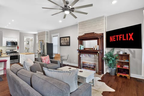 Living Room 1: Bright and welcoming living room with cozy seating, a smart TV, and plenty of natural light. The perfect place to relax, watch a movie, or gather with family after a day of exploring.