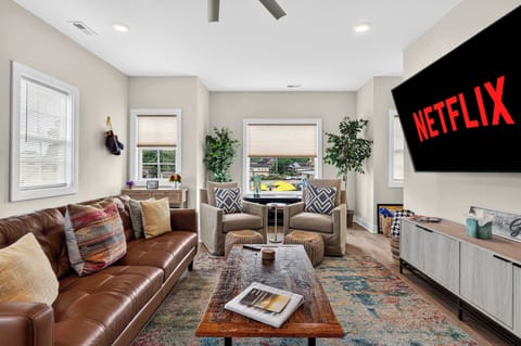 Living Room: Cozy couches and club chairs for reading, stream your shows on this 75 in TV or just relax!