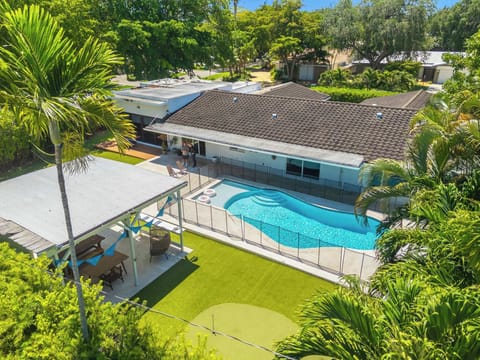 The back yard oasis boasts a private pool, putting green, lounge space, & more!​