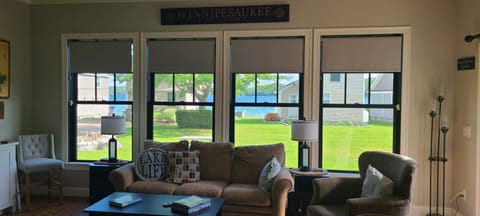 Unwind in your comfortable living room with stunning lake views through expansive windows. Picture yourself relaxing here after a day of lakeside adventures.