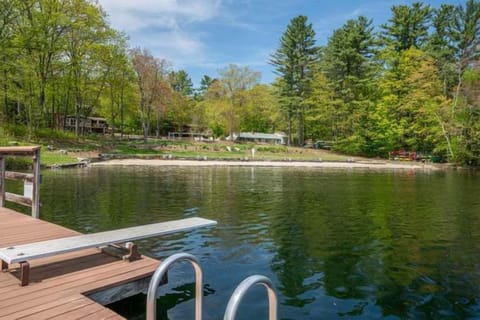 Serene lakefront property with private dock access, nestled among lush woodlands. The tranquil waters and natural surroundings create an ideal escape for relaxation and waterside activities.