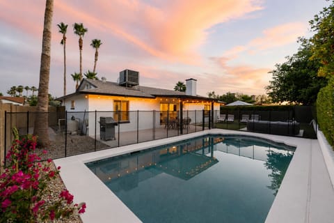 Golden hour magic - fenced heated pool, string lights, and palm trees for unforgettable Arizona evenings