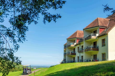 The residence's terraced architecture blends into the hillside, with sweeping views of the greens and the surrounding countryside.