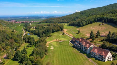 The residence sits at the edge of the course, with the Alsatian hills and vineyards forming a natural backdrop.