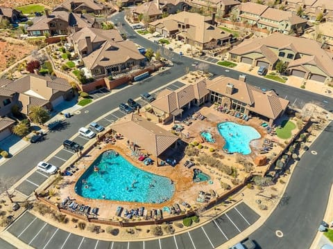Aerial view of community pool with sun loungers and shared amenities