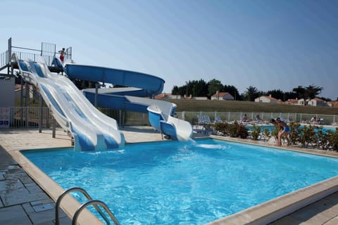 The water slides plunge straight into the outdoor pool — a highlight for families on the Vendée coast.