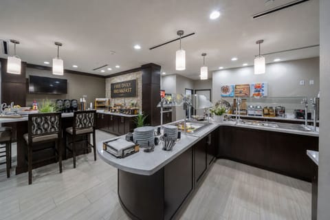 Savor a delicious free breakfast in a stylish dining area, complete with modern seating and fresh decor.