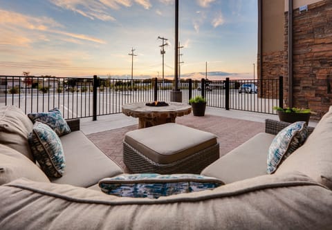 Comfortable outdoor seating surrounding a fire pit with a scenic view.