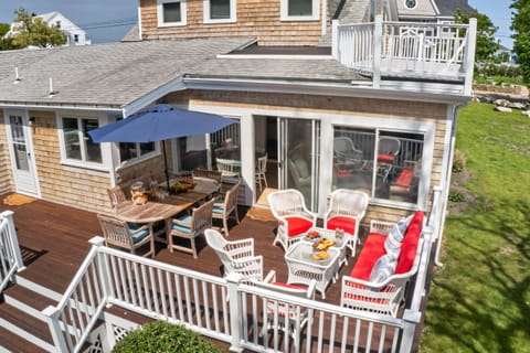 Patio area featuring comfortable outdoor seating and a dining table, set in a relaxing open-air space with a welcoming, well-maintained ambiance and natural light.