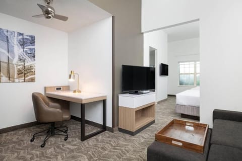 Settle into your spacious suite with desk, TV, and comfort.