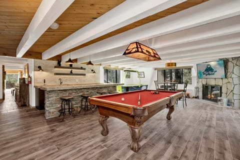 A fun game room with games perfect for family fun, friendly competition, and unforgettable entertainment during your stay. The space also features comfy seating and a TV, making it a great spot to relax and enjoy time together.