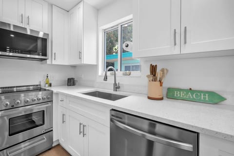 Kitchen comes stocked with utensils, plates, and basic cookware, ideal for easy cooking and everyday meals.