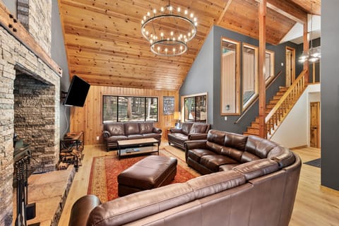 Living Room with Large Windows & Wood-Burning Fireplace
