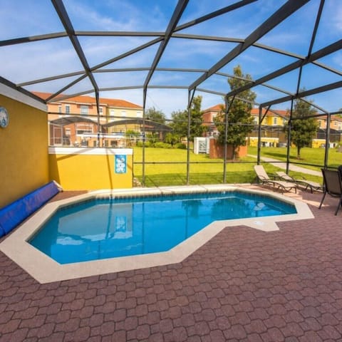 Relax in the private screened pool with sunny patio and lounging chairs.