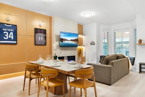 Modern living room with cozy seating, Smart TV, and sleek fireplace ambiance