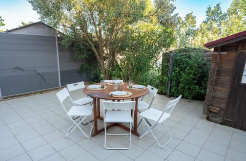 Large terrace with garden furniture and an awning