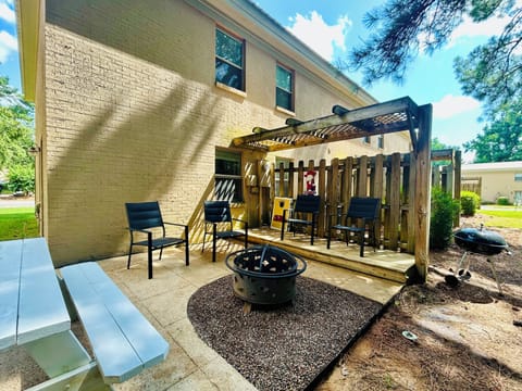 Private patio with fire pit, pergola seating, and grill for outdoor fun