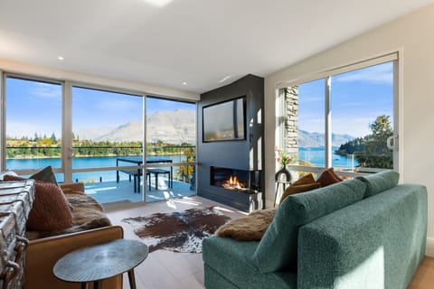 The living room from the deck - fireplace at centre, lake on two sides