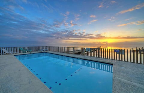 Waterfront community pool with loungers.