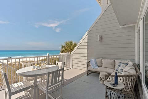 Expansive private balcony offering a comfortable lounge sofa and breathtaking views of the ocean.