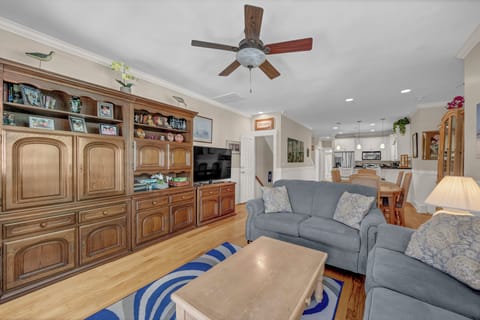 Unwind in your spacious living area with plush seating, warm wood cabinetry, and an open flow to the dining space and kitchen—perfect for relaxing after a day of adventure.