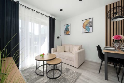 Bright living area with a comfortable sofa, dining table and access to the terrace.