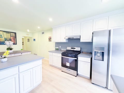 Fully equipped kitchen with coffee maker, microwave, and cooking essentials