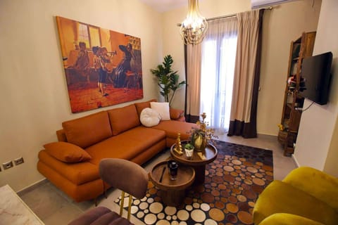 The living area combines warm colours, comfortable seating, and carefully selected décor, creating an inviting space to unwind after exploring Nafplio's waterfront, beaches, and historic streets.