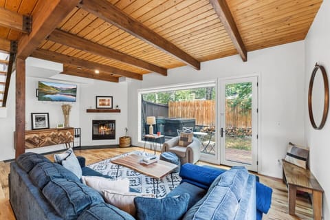 Open concept modern living room with fireplace and smart tv