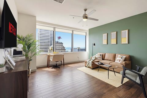 Stretch out and relax in this bright living room with comfy seating, plenty of natural light, and city views right outside the windows.