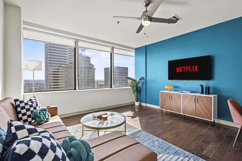 Soak in the city views from this bright living room, then get cozy on the sofa and catch up on your favorite shows.