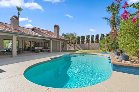 Private backyard oasis featuring a sparkling pool, covered patio lounge, outdoor dining area, BBQ grill, and plenty of space to soak up the Arizona sunshine.
