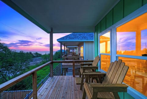 Sunset porch with Adirondack seating, bay breezes, and colorful cottage charm.