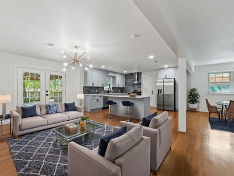Unwind in your spacious open-concept living space with modern kitchen, cozy seating area, and stylish dining nook - perfect for memorable gatherings.