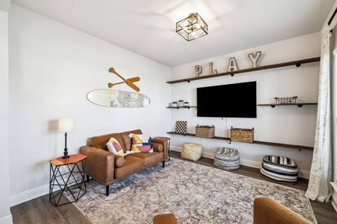 Your cozy game room awaits with comfortable seating and entertainment setup for relaxing evenings.
