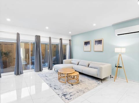 Open-Concept Living Room with Plush Sofa, Coastal Decor & Sliding Glass Doors