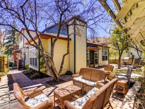 Escape to this private tranquil courtyard oasis, complete with a lounging table, grill, and lush greenery.