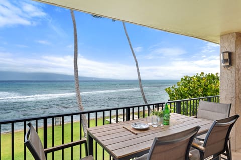 Outdoor table for meals while enjoying direct oceanfront scenery.