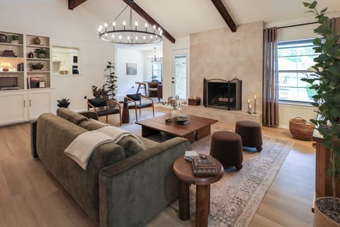Living Room with fireplace, built-in shelves, kitchen nook, elegant framed 65" Canvas 4K QLED TV with Hi-Matte Display and UltraSlim Wall Mount, perfect for gathering and savoring every moment.