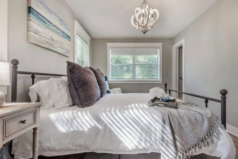 Charming Bedroom: Enjoy sunlit mornings and plush pillows in this serene retreat!