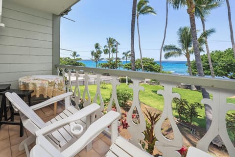 Relax on your private balcony with stunning sea views framed by swaying palms. Watch the azure ocean shimmer beyond the lush tropical gardens while you unwind in coastal serenity.