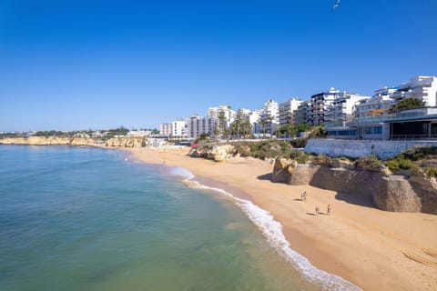On the beach, white sand, beach cabanas, sun loungers