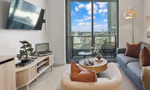 Bright living area with skyline views and smart TV